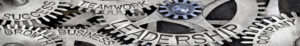 Metal gears with "success, growth, business, teamwork, leadership, company" engraved on them.
