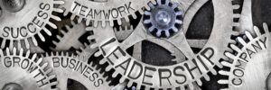 Macro photo of tooth wheel mechanism with LEADERSHIP, TEAMWORK, SUCCESS, COMPANY, GROWTH and BUSINESS concept letters