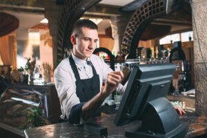 guy swiping credit card at bar