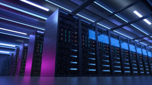 Wide angle shot of rows of server cabinets lined up next to each other in working data center. Led lights on server cabinets. Room illuminated by purple glow from lighting.