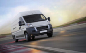 blurred photo of Caspian work truck going to site to provide help