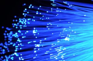 Blue fiber cabling cable ends illuminated and shining.