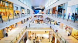 blurred retail shopping mall with people on multiple floors
